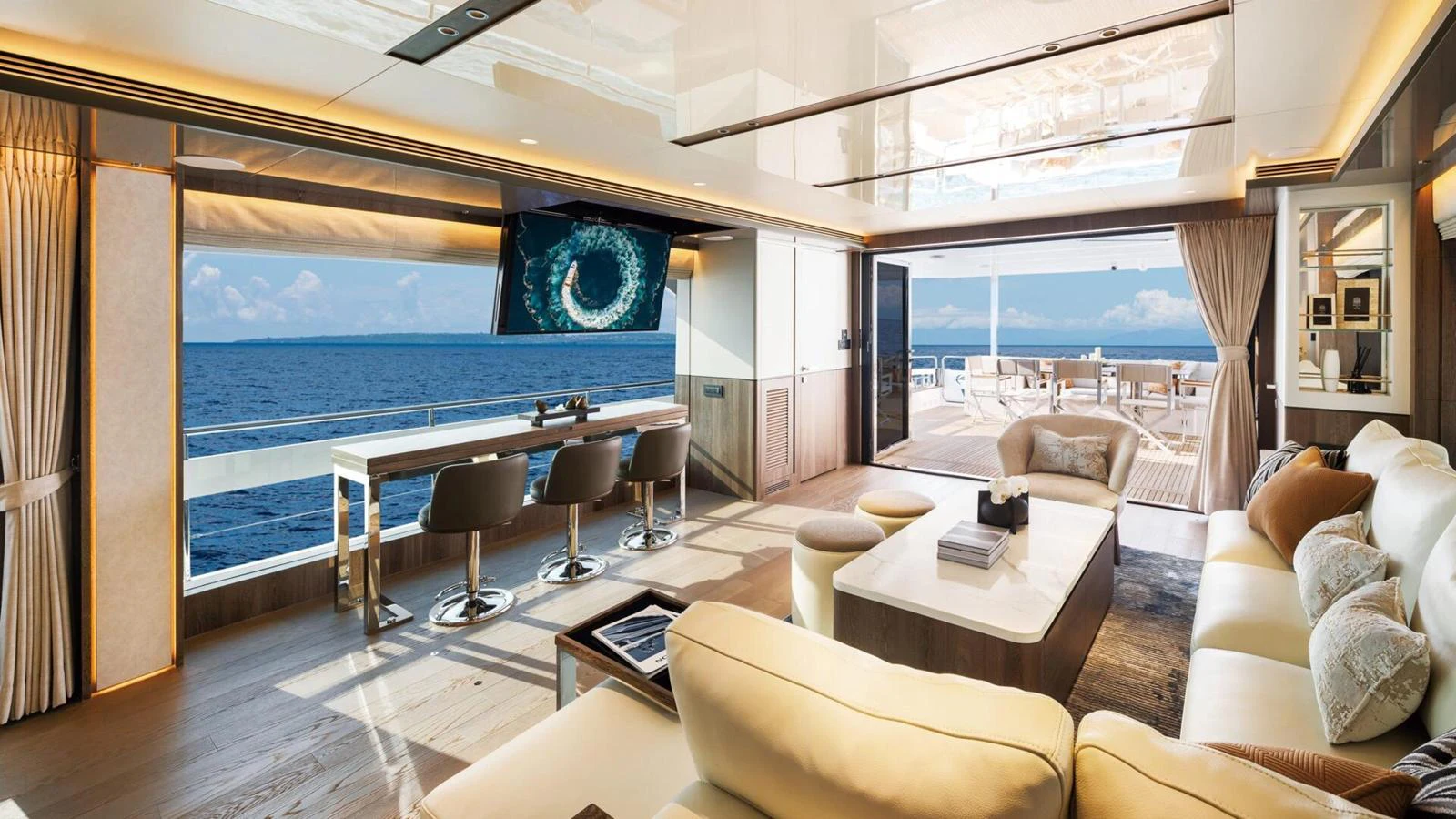 The spacious salon offers stunning ocean views and luxurious seating. aboard HAPPY HEART Yacht for Sale