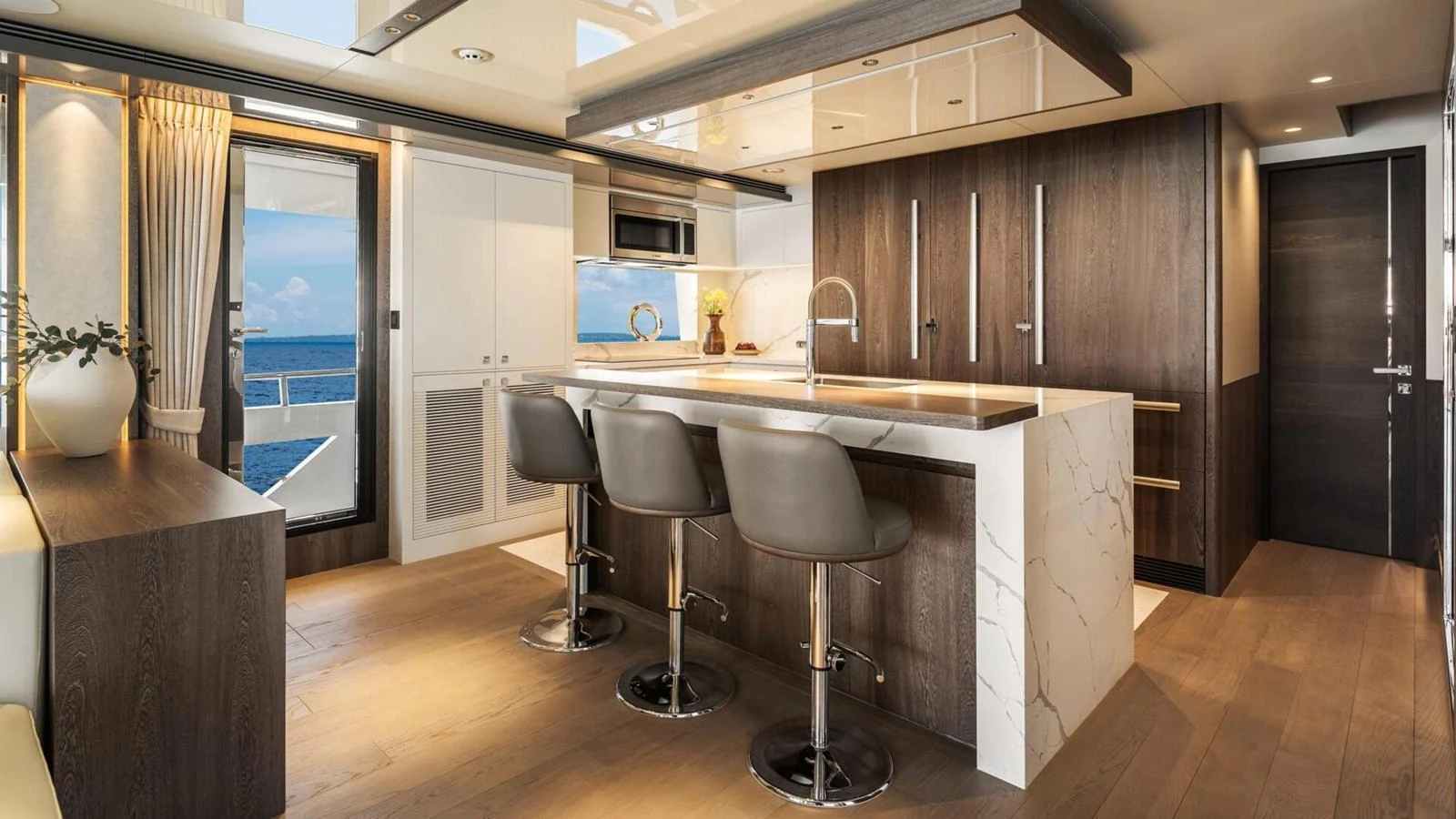 The yacht's galley features a modern design with sleek finishes and ample seating. aboard HAPPY HEART Yacht for Sale