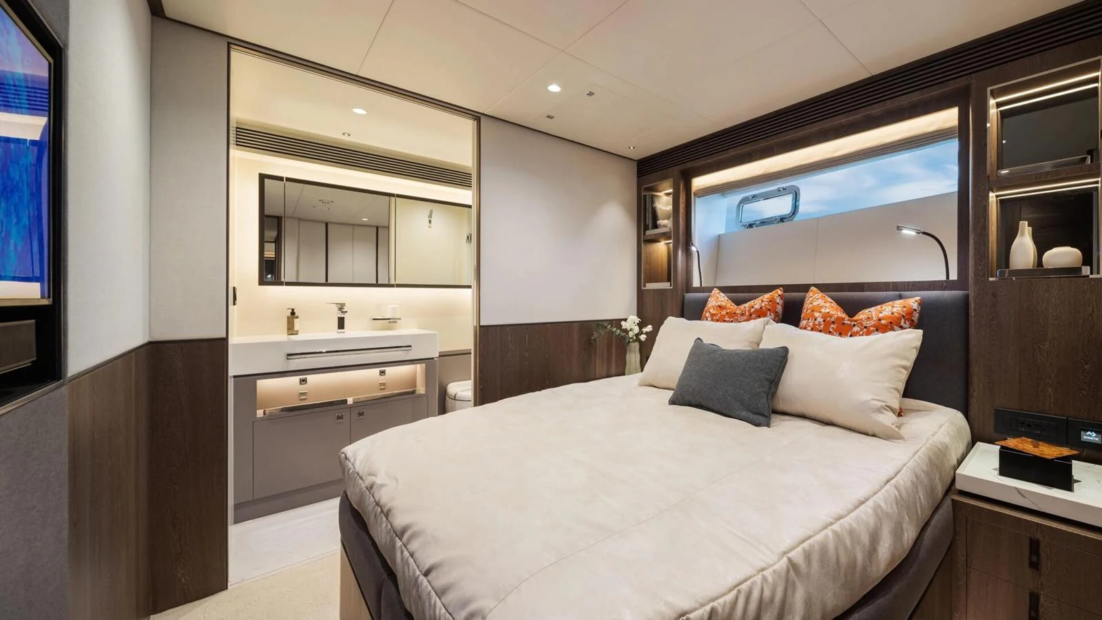 The stateroom features a plush bed with elegant bedding and a modern ensuite bathroom. aboard HAPPY HEART Yacht for Sale