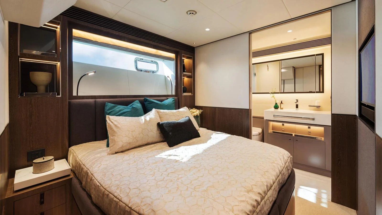 A luxurious stateroom featuring a comfortable bed and an ensuite bathroom. aboard HAPPY HEART Yacht for Sale
