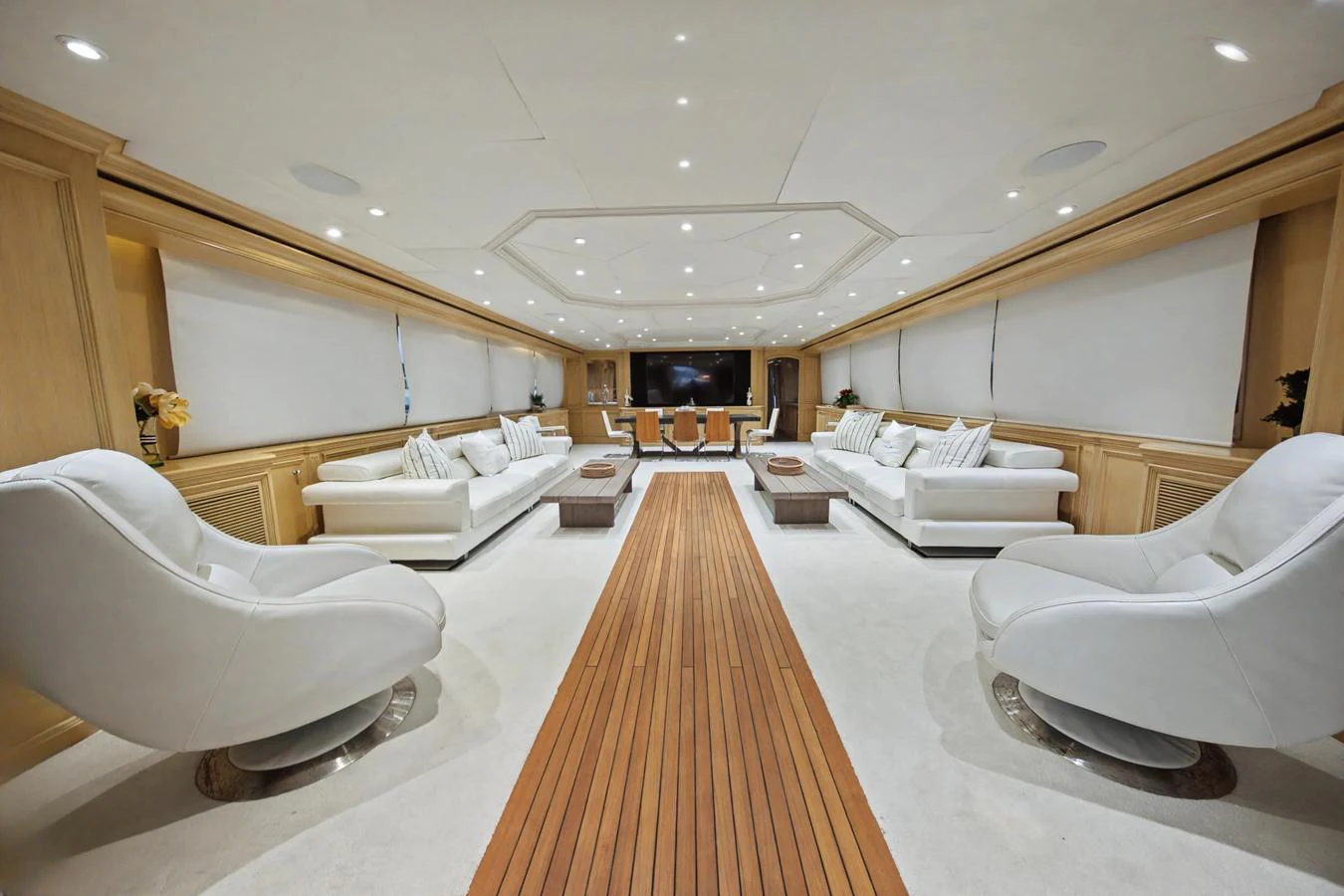 The spacious salon features luxurious seating and elegant wood accents, creating a comfortable and inviting atmosphere. aboard SAVOIR-FAIRE Yacht for Sale