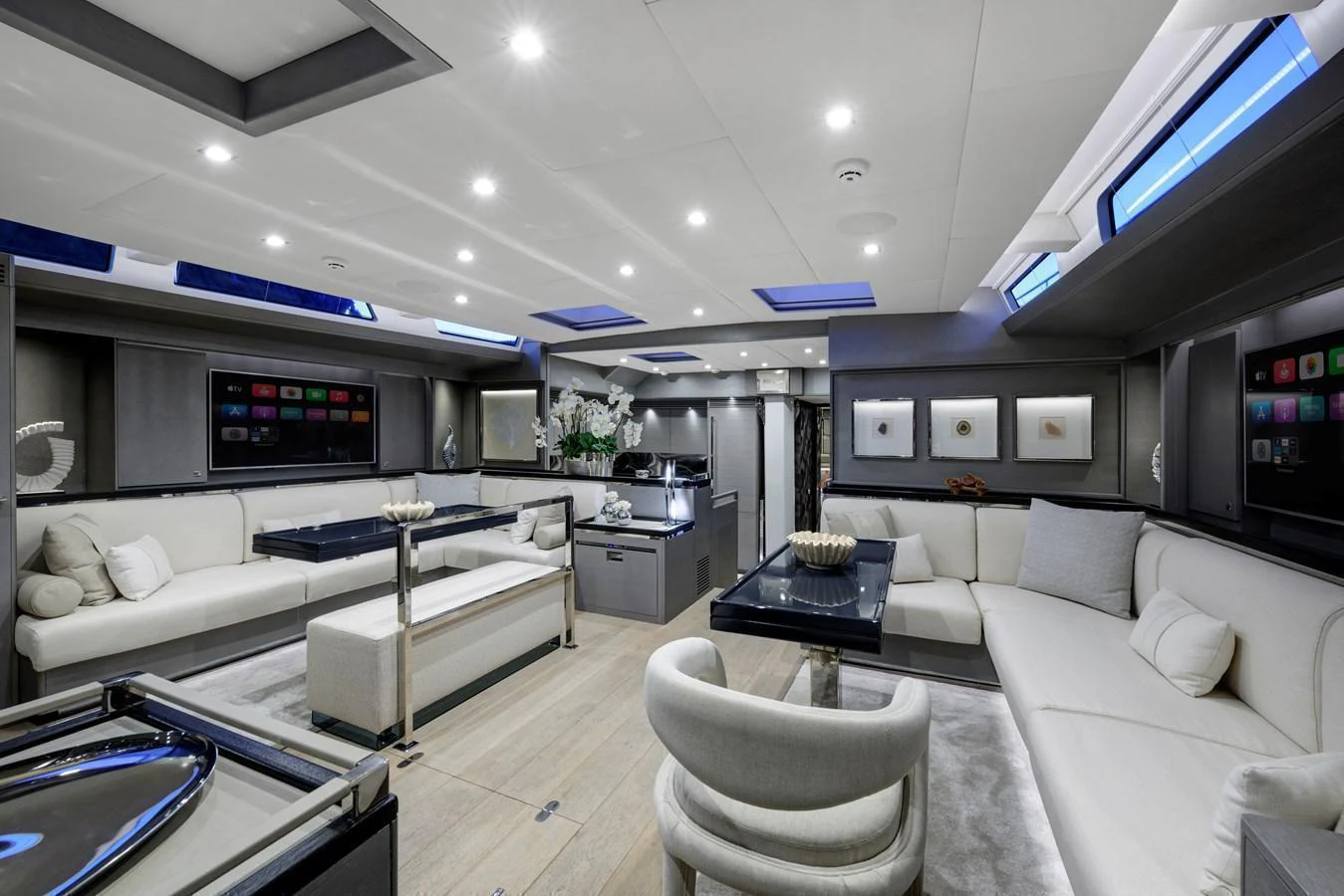 The salon features modern decor with plush seating and ample natural light. aboard MISHI Yacht for Sale