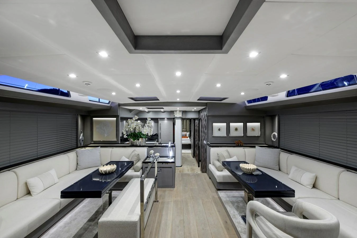 The salon features elegant seating arrangements with modern decor and ample natural light. aboard MISHI Yacht for Sale