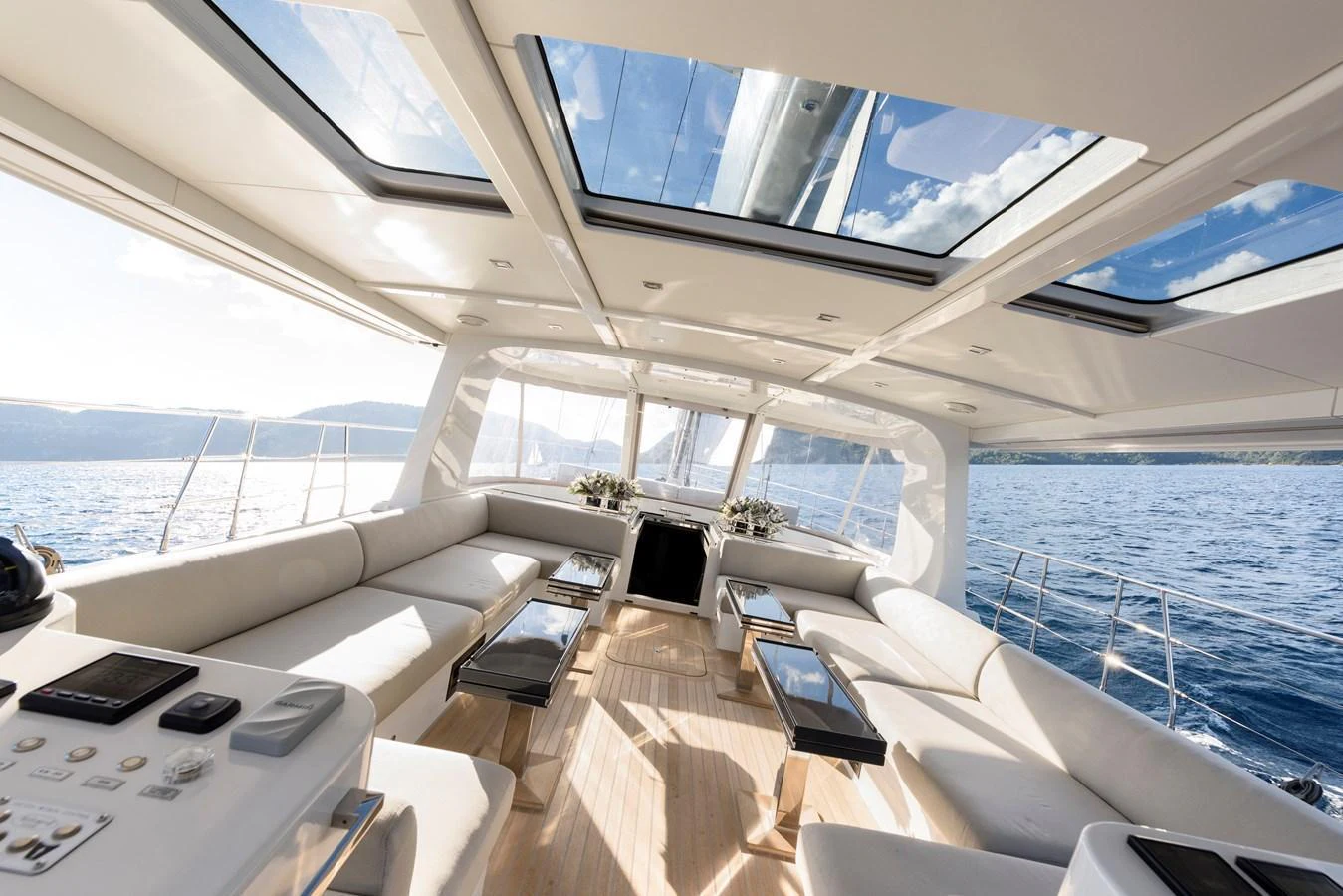 The yacht's salon features expansive windows and skylights, offering panoramic views and abundant natural light. aboard MISHI Yacht for Sale