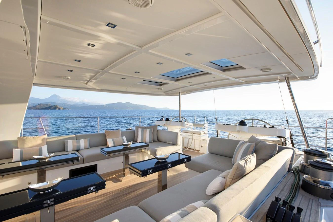 The aft deck offers a spacious and luxurious seating area with stunning ocean views. aboard MISHI Yacht for Sale