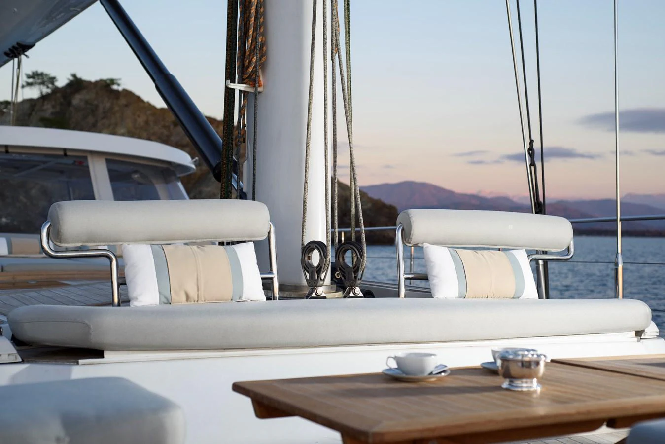 Comfortable deck seating area with a table set for relaxation and dining. aboard MISHI Yacht for Sale
