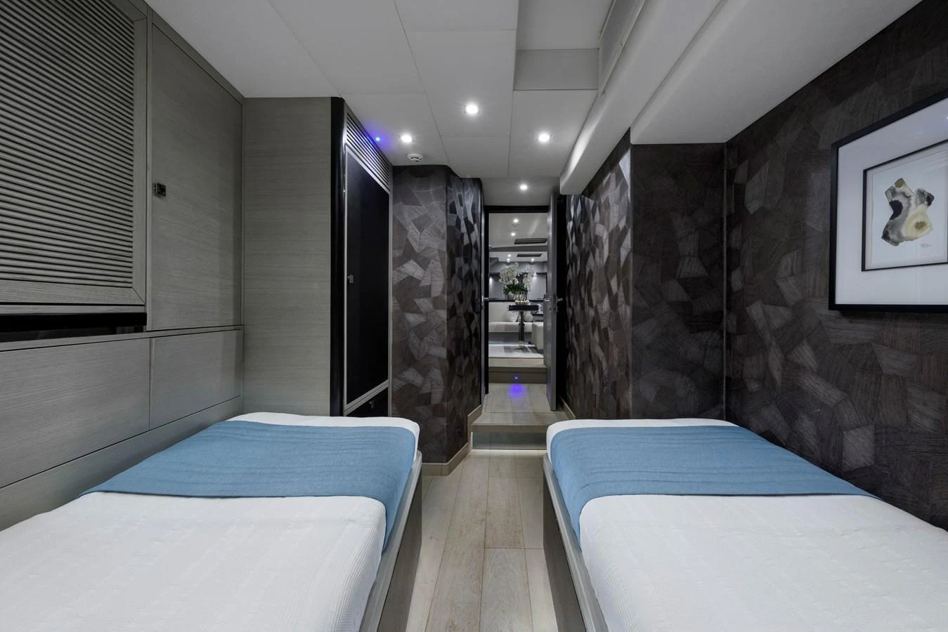 The guest stateroom features twin beds with modern decor and ambient lighting. aboard MISHI Yacht for Sale