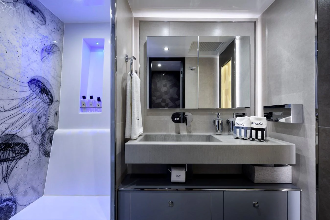 The yacht's bathroom features a modern design with sleek fixtures and a stylish shower area. aboard MISHI Yacht for Sale