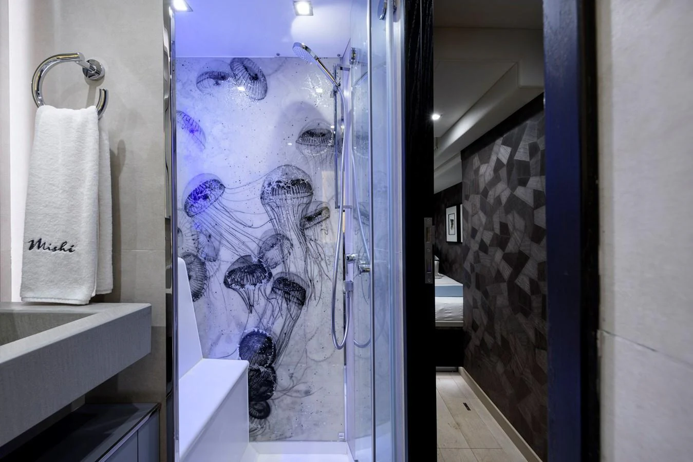 A stylish yacht bathroom featuring a modern shower with a jellyfish-themed glass panel. aboard MISHI Yacht for Sale