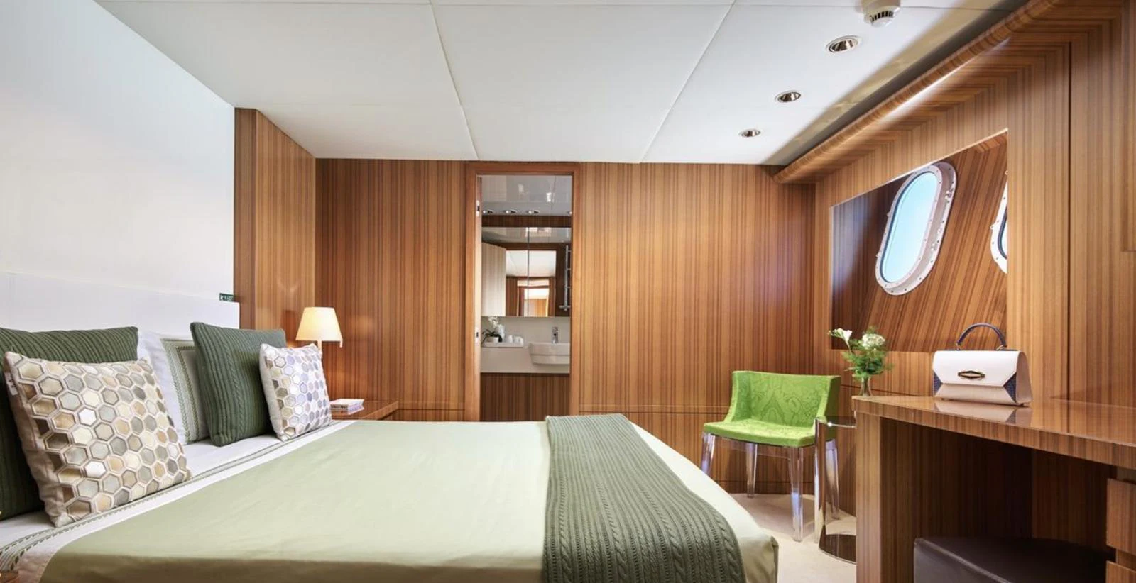 A luxurious stateroom featuring elegant wood paneling and modern furnishings. aboard SEA SHELL Yacht for Sale