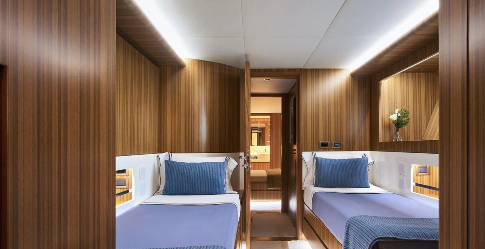 The twin stateroom features elegant wood paneling and comfortable bedding, creating a cozy and inviting atmosphere. aboard SEA SHELL Yacht for Sale