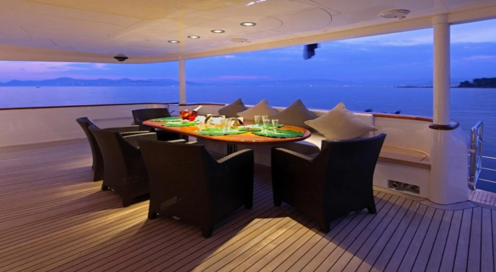 The aft deck features a stylish dining area with a stunning ocean view. aboard SEA SHELL Yacht for Sale