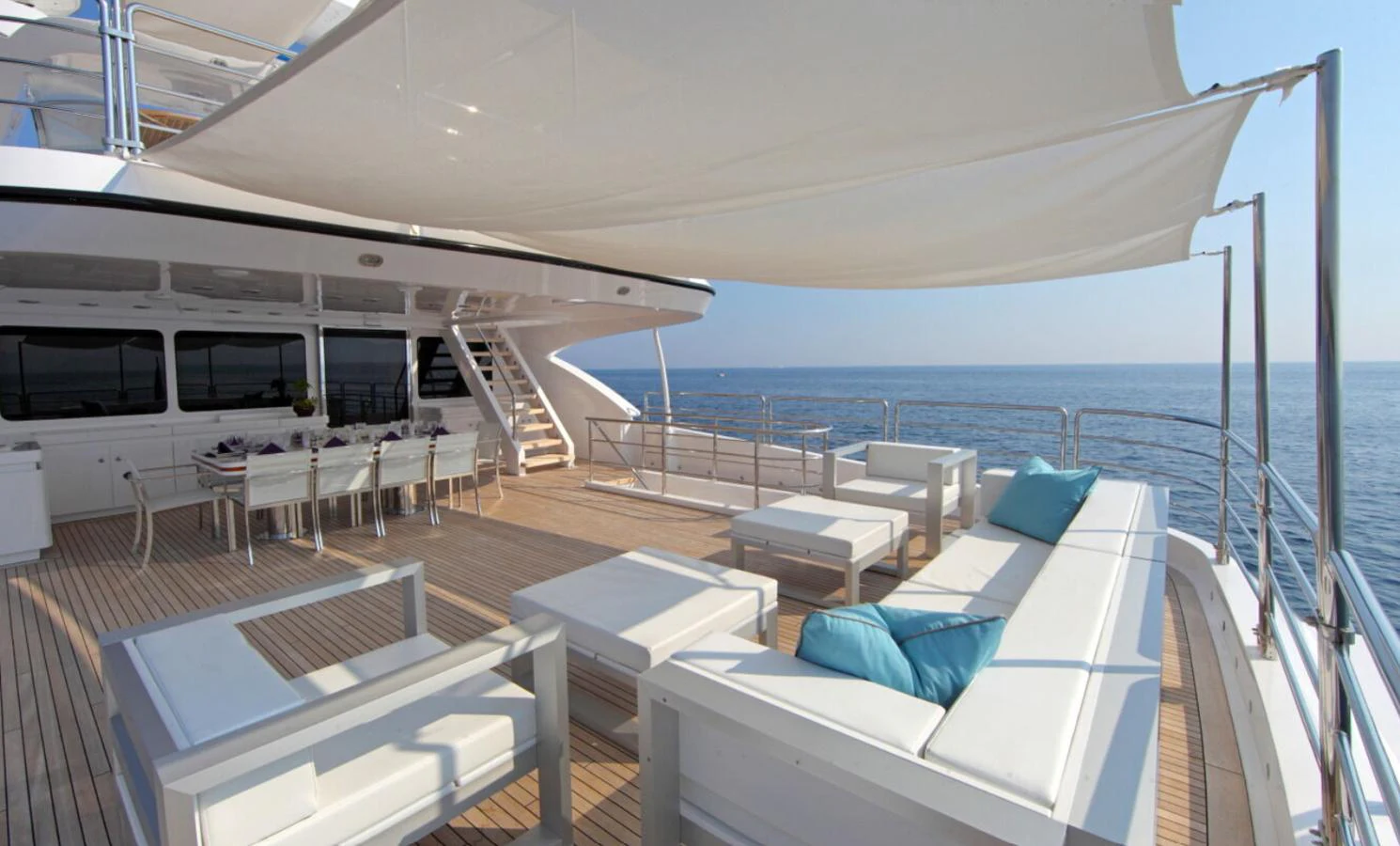 The spacious aft deck features comfortable seating and dining areas with a stunning ocean view. aboard SEA SHELL Yacht for Sale
