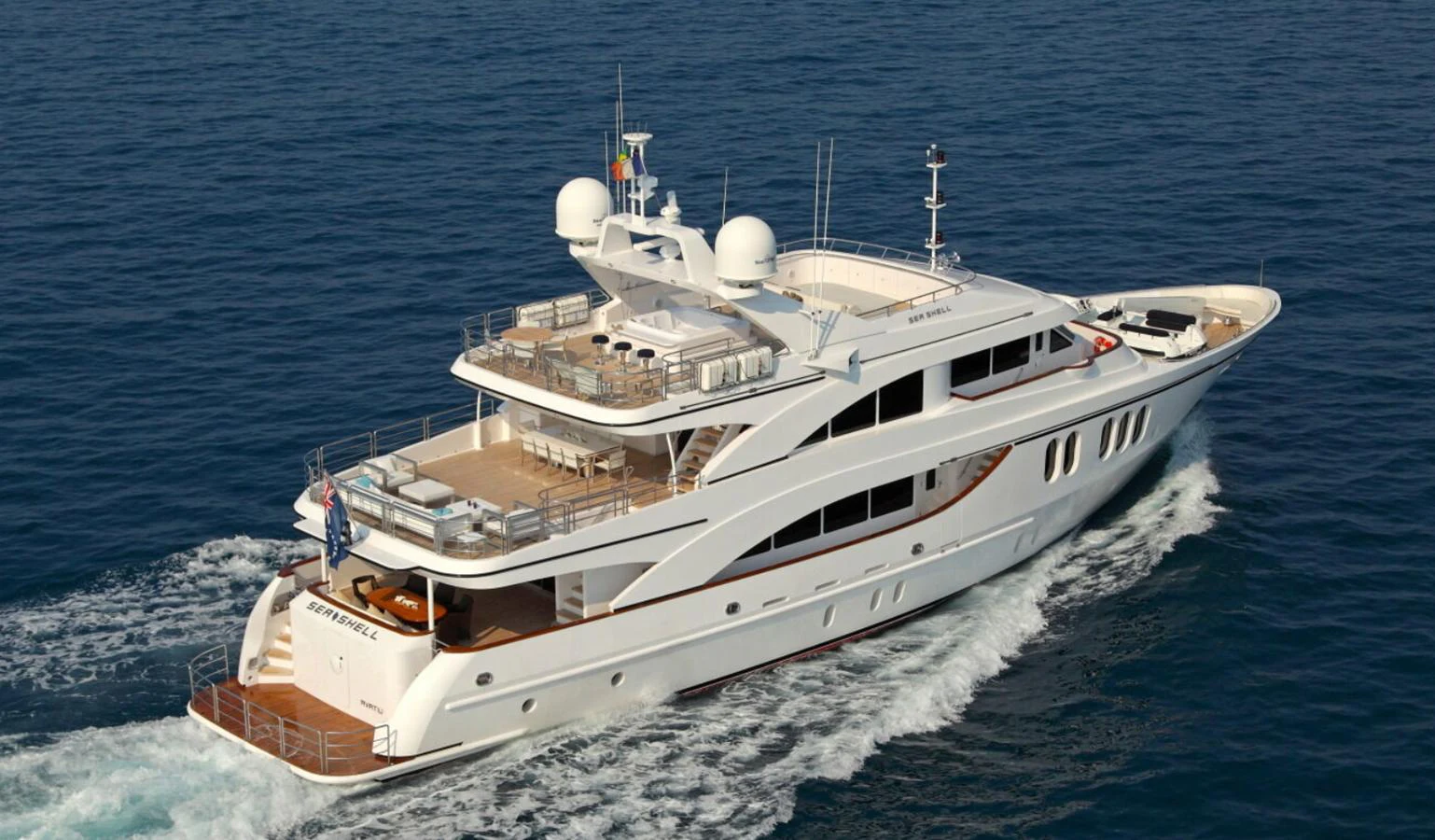 A luxurious yacht cruises through the open sea, showcasing its elegant design and spacious decks. aboard SEA SHELL Yacht for Sale