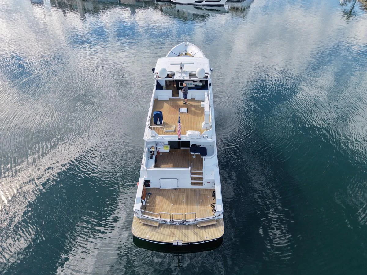 Aerial view of a yacht docked in calm waters, showcasing its spacious decks and sleek design. aboard BURNING DAYLIGHT Yacht for Sale