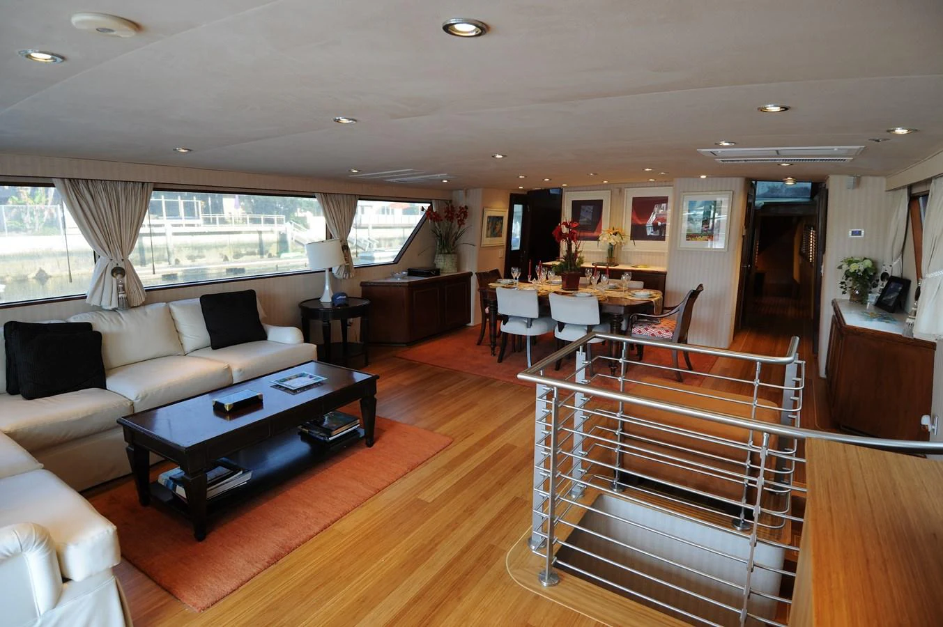 The yacht's salon features a spacious and elegantly furnished living and dining area with ample natural light. aboard BURNING DAYLIGHT Yacht for Sale