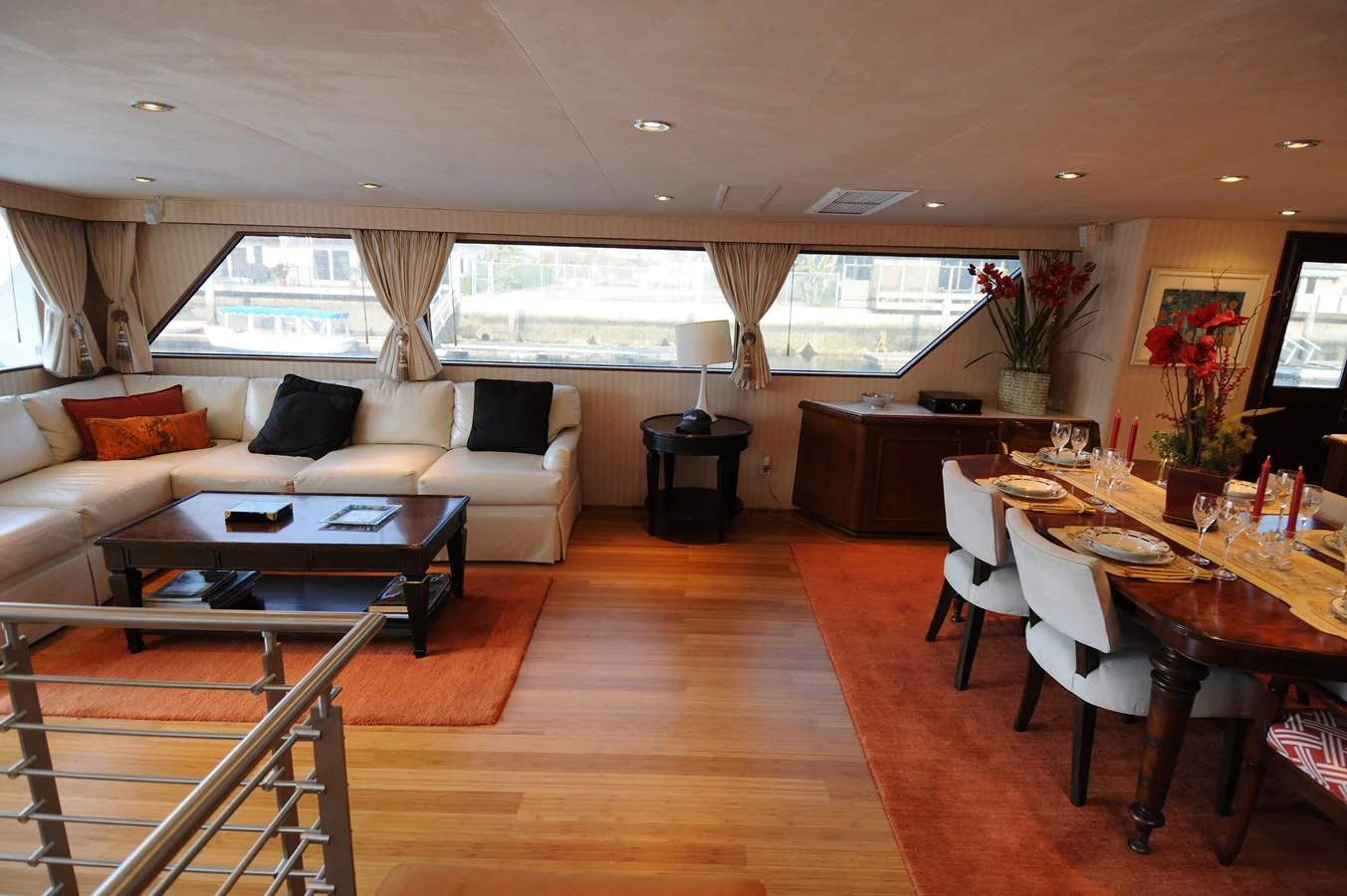 The salon features a spacious seating area with a dining table, creating a warm and inviting atmosphere. aboard BURNING DAYLIGHT Yacht for Sale