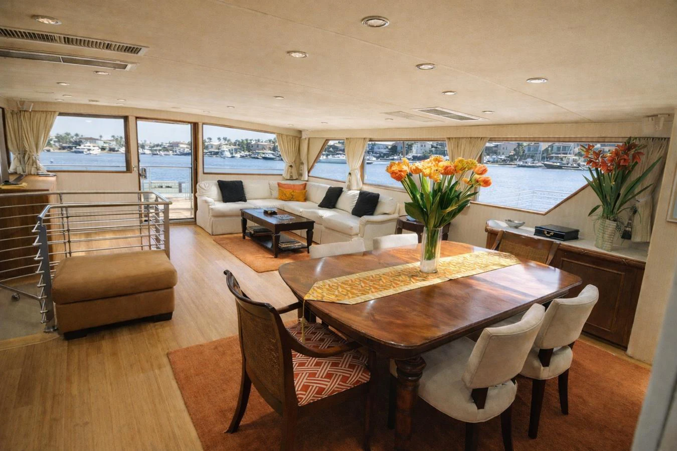 The salon features a spacious and elegant seating area with large windows offering stunning water views. aboard BURNING DAYLIGHT Yacht for Sale