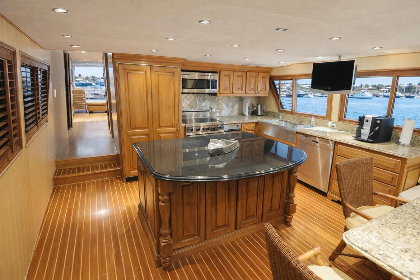 The galley features a spacious layout with a central island, wooden cabinetry, and modern appliances. aboard BURNING DAYLIGHT Yacht for Sale