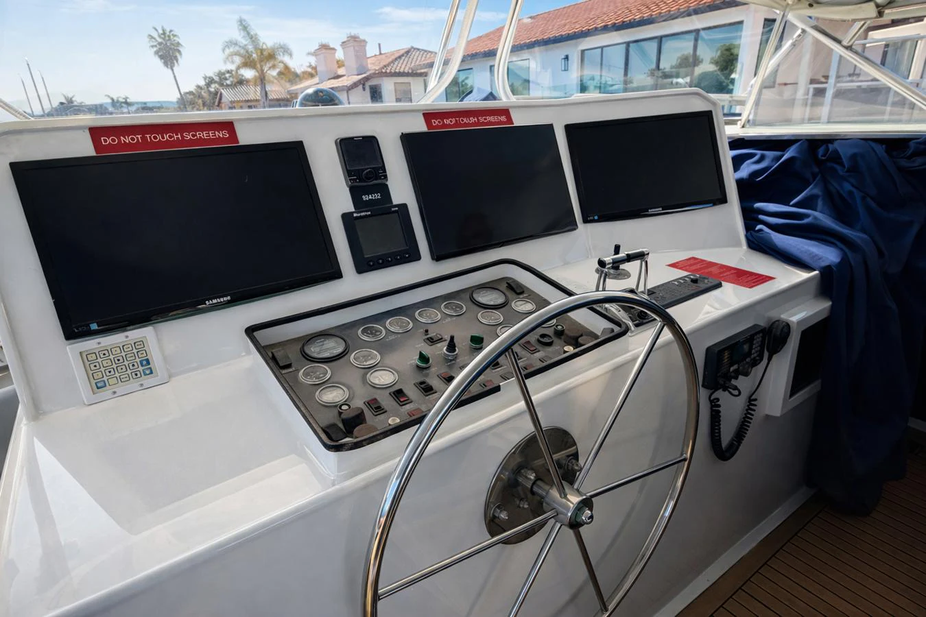 The helm station features a modern control panel with multiple screens and a sleek steering wheel. aboard BURNING DAYLIGHT Yacht for Sale