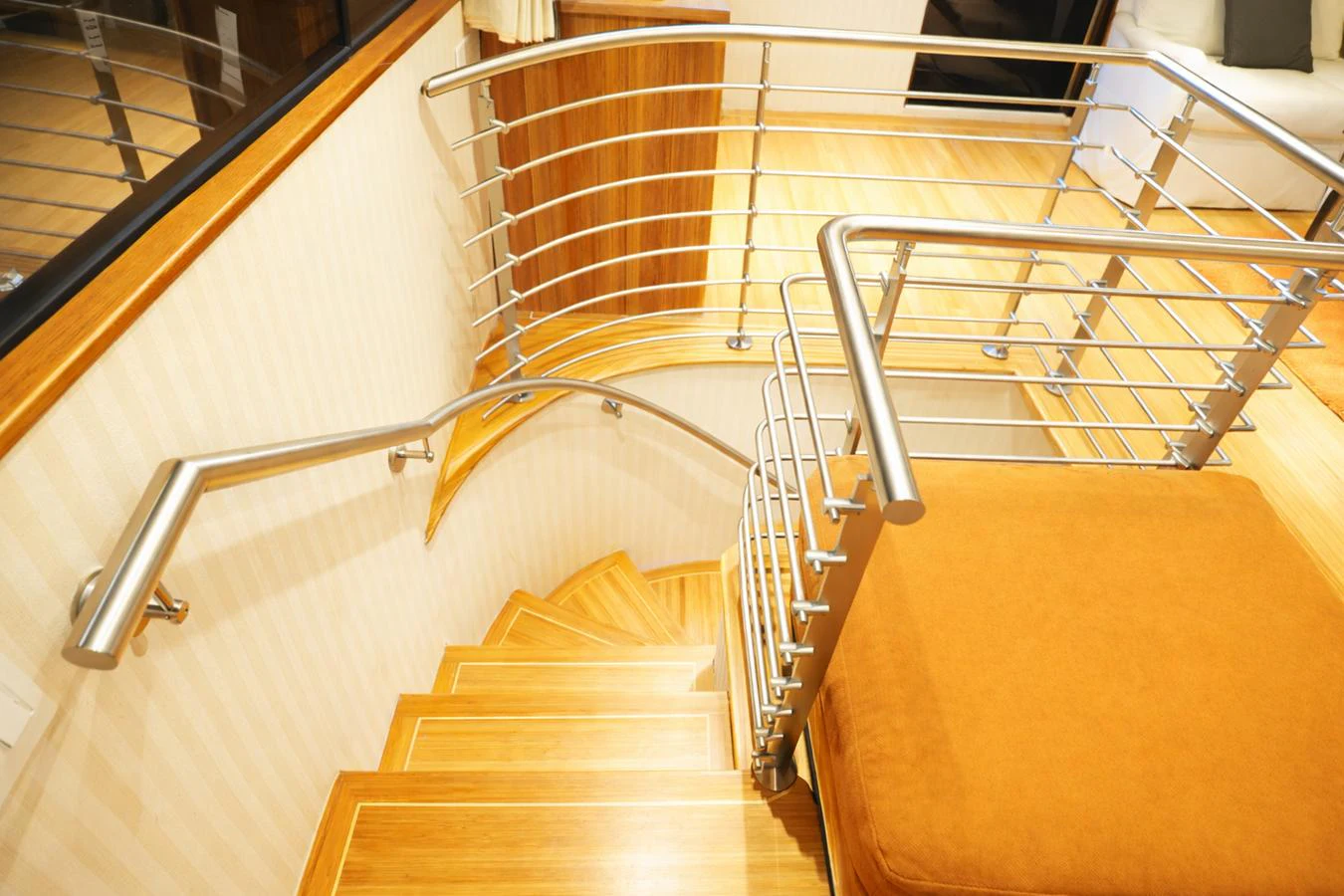 A sleek and modern staircase with wooden steps and stainless steel railings inside the yacht. aboard BURNING DAYLIGHT Yacht for Sale