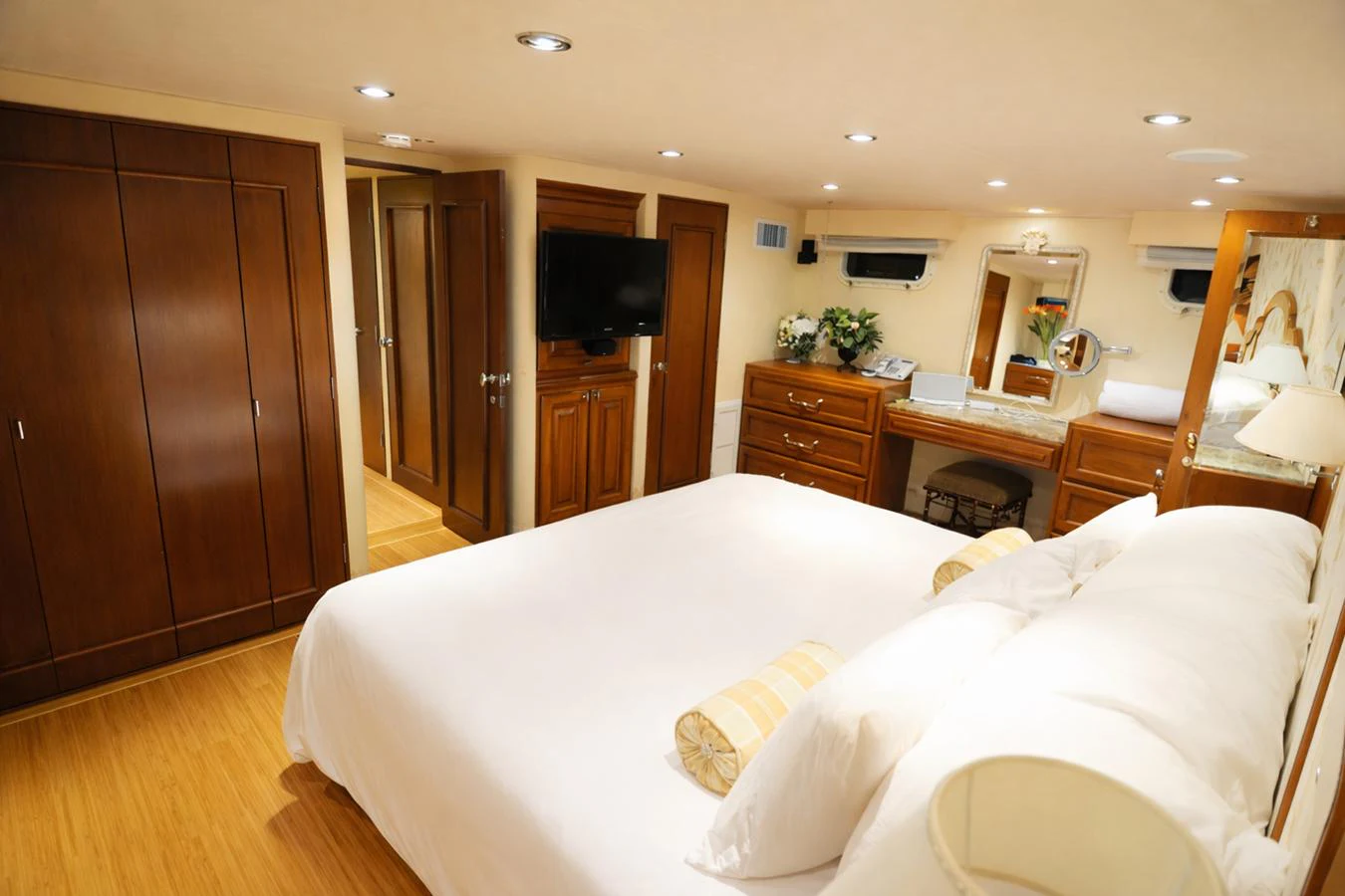 The master stateroom features a luxurious bed, ample storage, and elegant decor. aboard BURNING DAYLIGHT Yacht for Sale