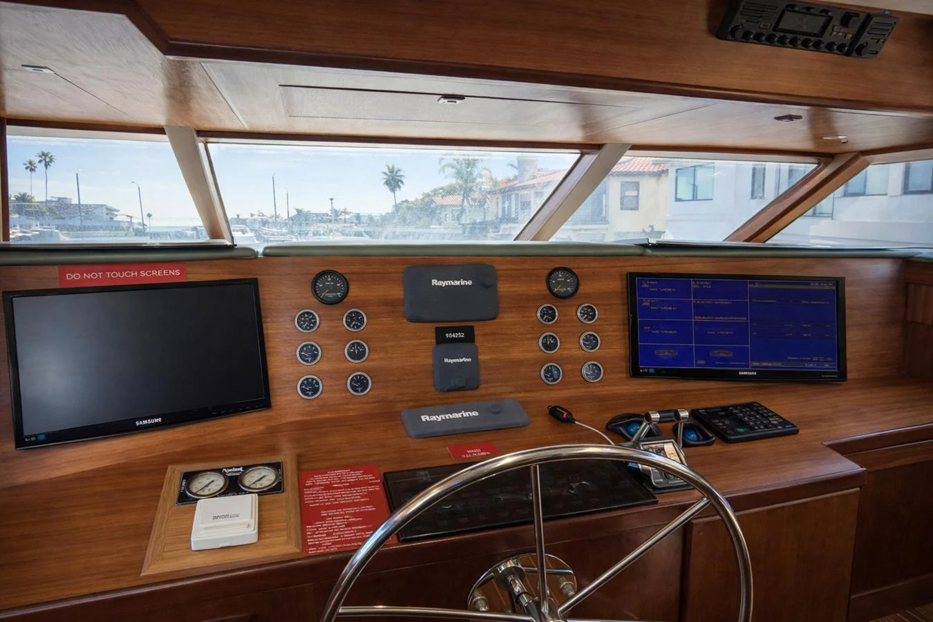 The helm station features modern navigation equipment and a classic wooden finish. aboard BURNING DAYLIGHT Yacht for Sale