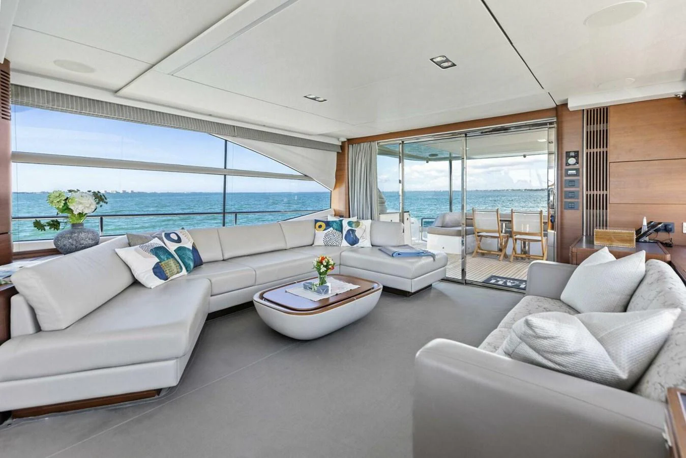 The spacious salon features elegant seating with panoramic ocean views. aboard 3BBOYS Yacht for Sale