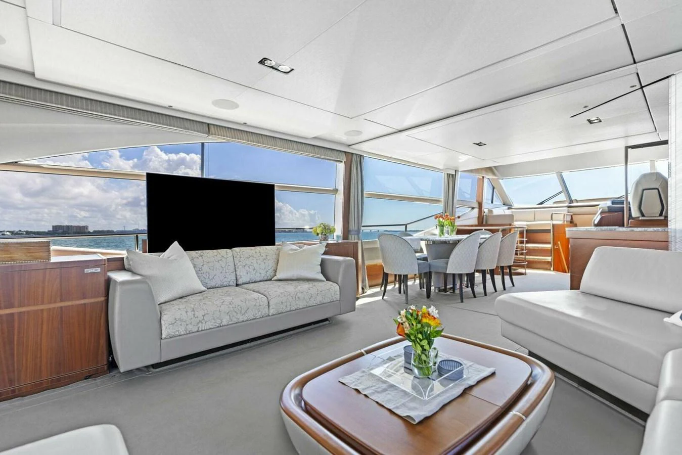 The spacious salon features elegant seating, a dining area, and large windows offering panoramic views. aboard 3BBOYS Yacht for Sale