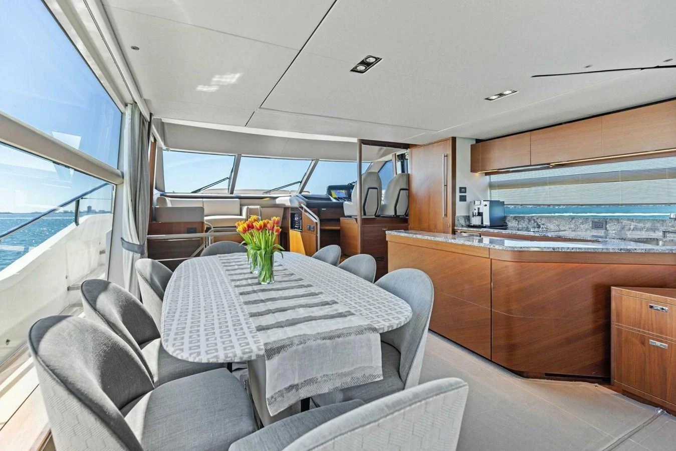 The salon features a spacious dining area with panoramic views and modern furnishings. aboard 3BBOYS Yacht for Sale