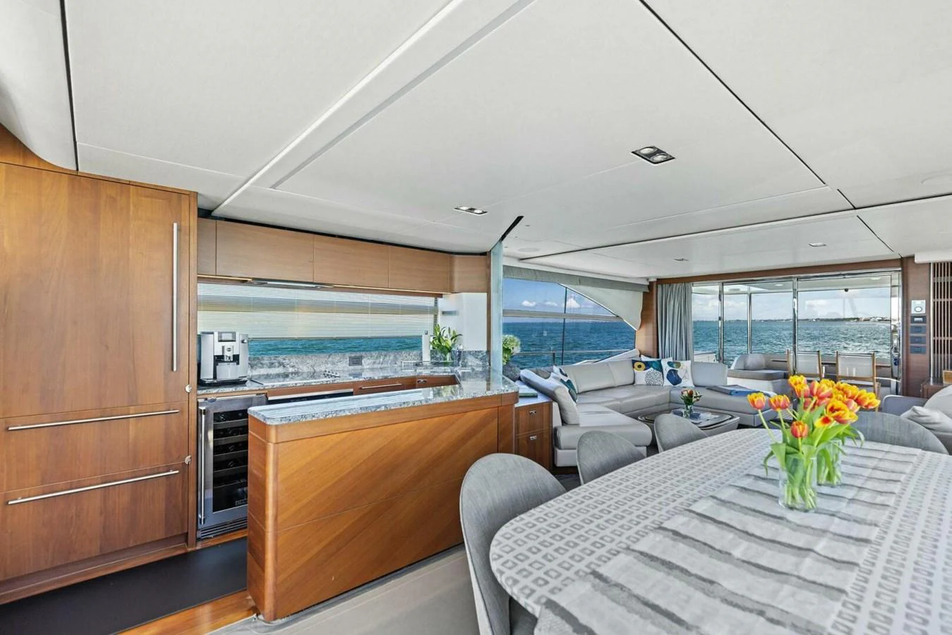 The spacious salon features elegant furnishings and panoramic ocean views. aboard 3BBOYS Yacht for Sale