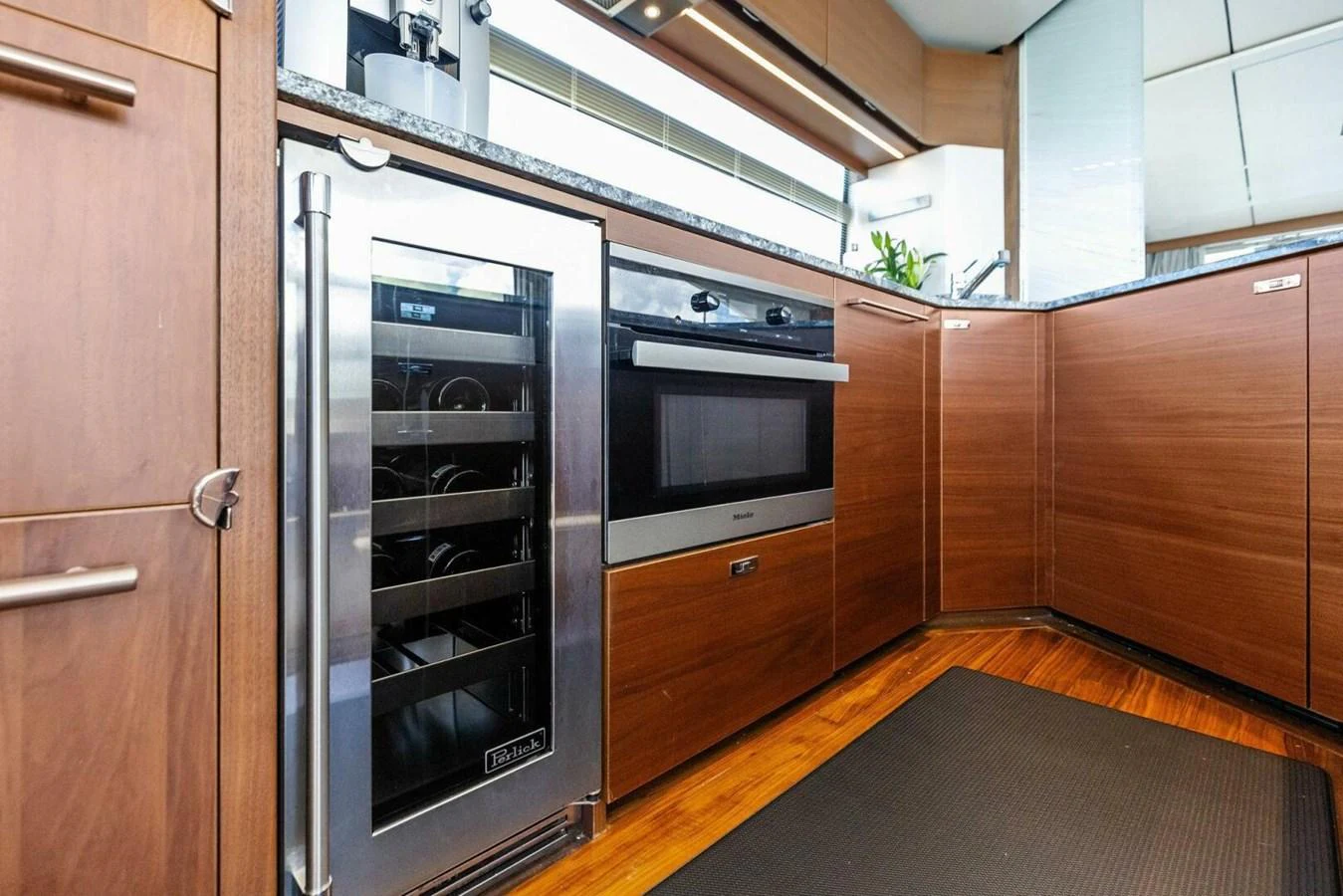 The yacht's galley features modern appliances and sleek wooden cabinetry. aboard 3BBOYS Yacht for Sale