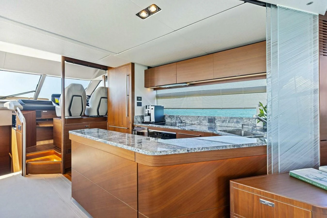 The galley features modern appliances and elegant wood cabinetry. aboard 3BBOYS Yacht for Sale