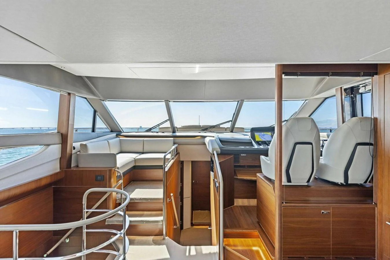 The helm area features modern seating and expansive windows offering panoramic views. aboard 3BBOYS Yacht for Sale