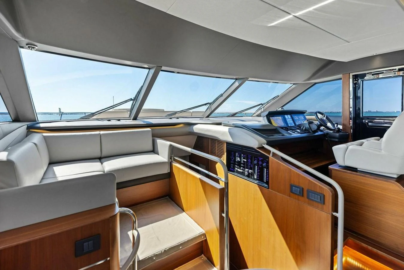 The helm area features modern navigation equipment and comfortable seating with panoramic views. aboard 3BBOYS Yacht for Sale