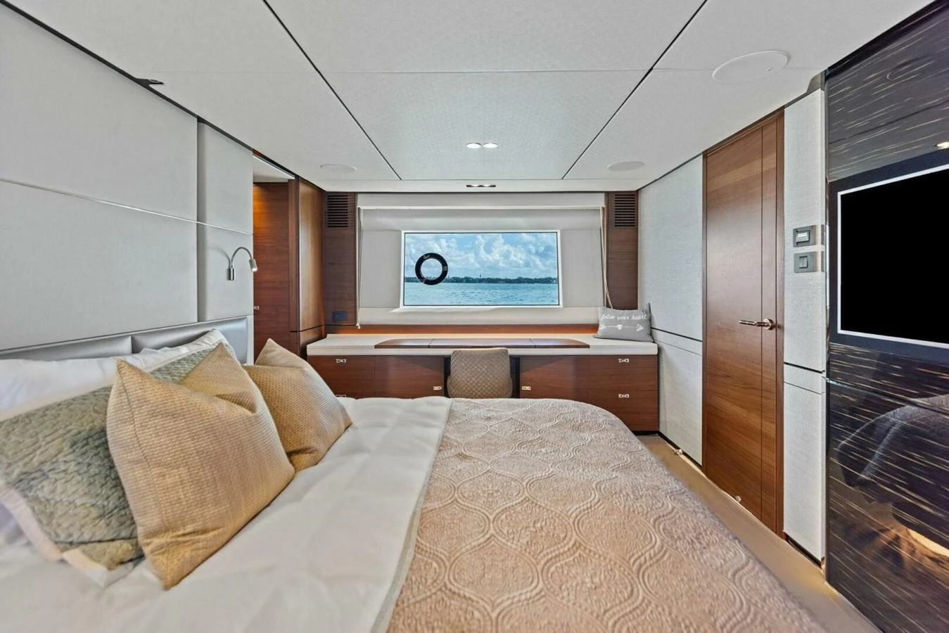 A luxurious stateroom with a comfortable bed and a scenic view through the window. aboard 3BBOYS Yacht for Sale