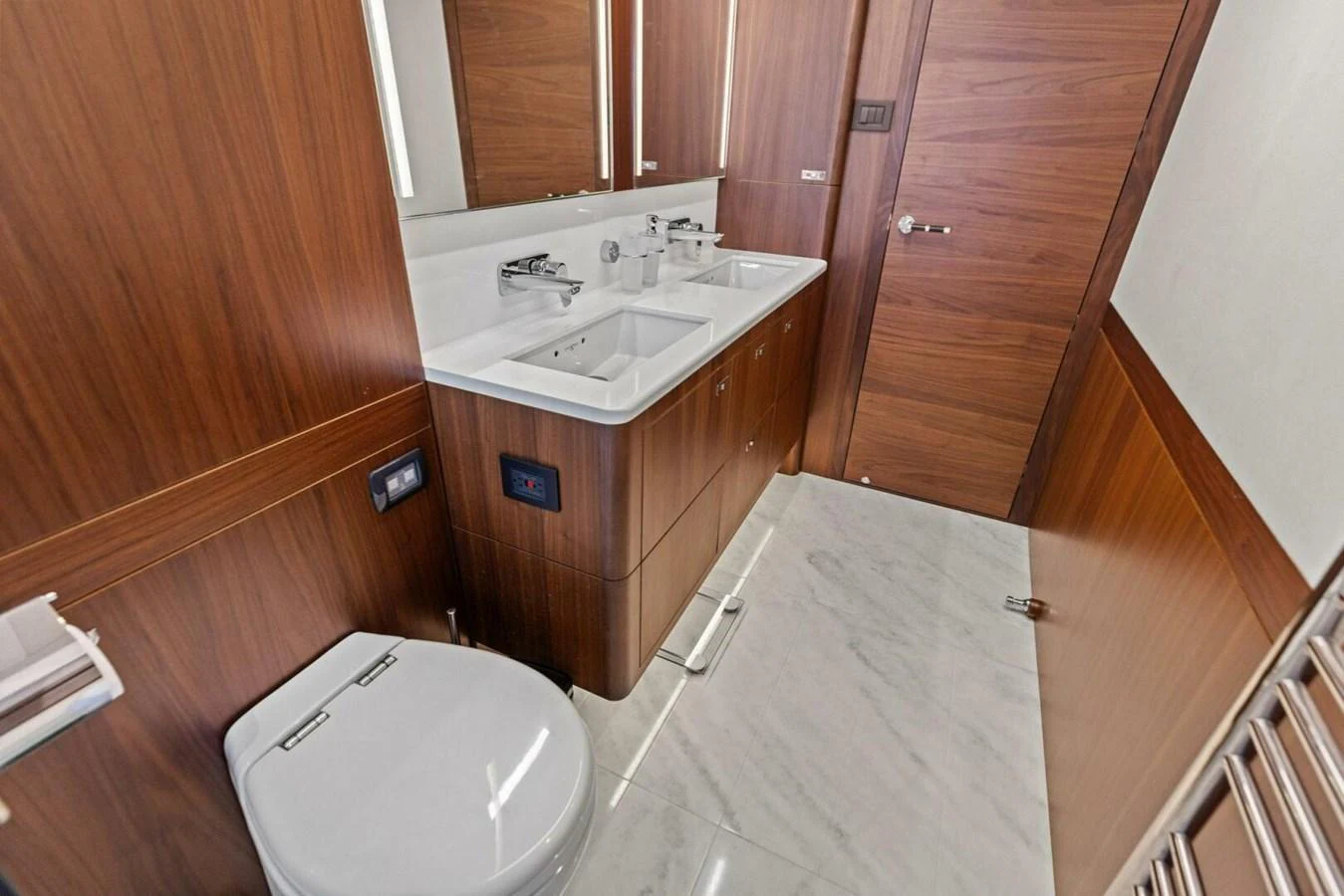 The yacht's bathroom features elegant wood paneling and a sleek, modern design. aboard 3BBOYS Yacht for Sale