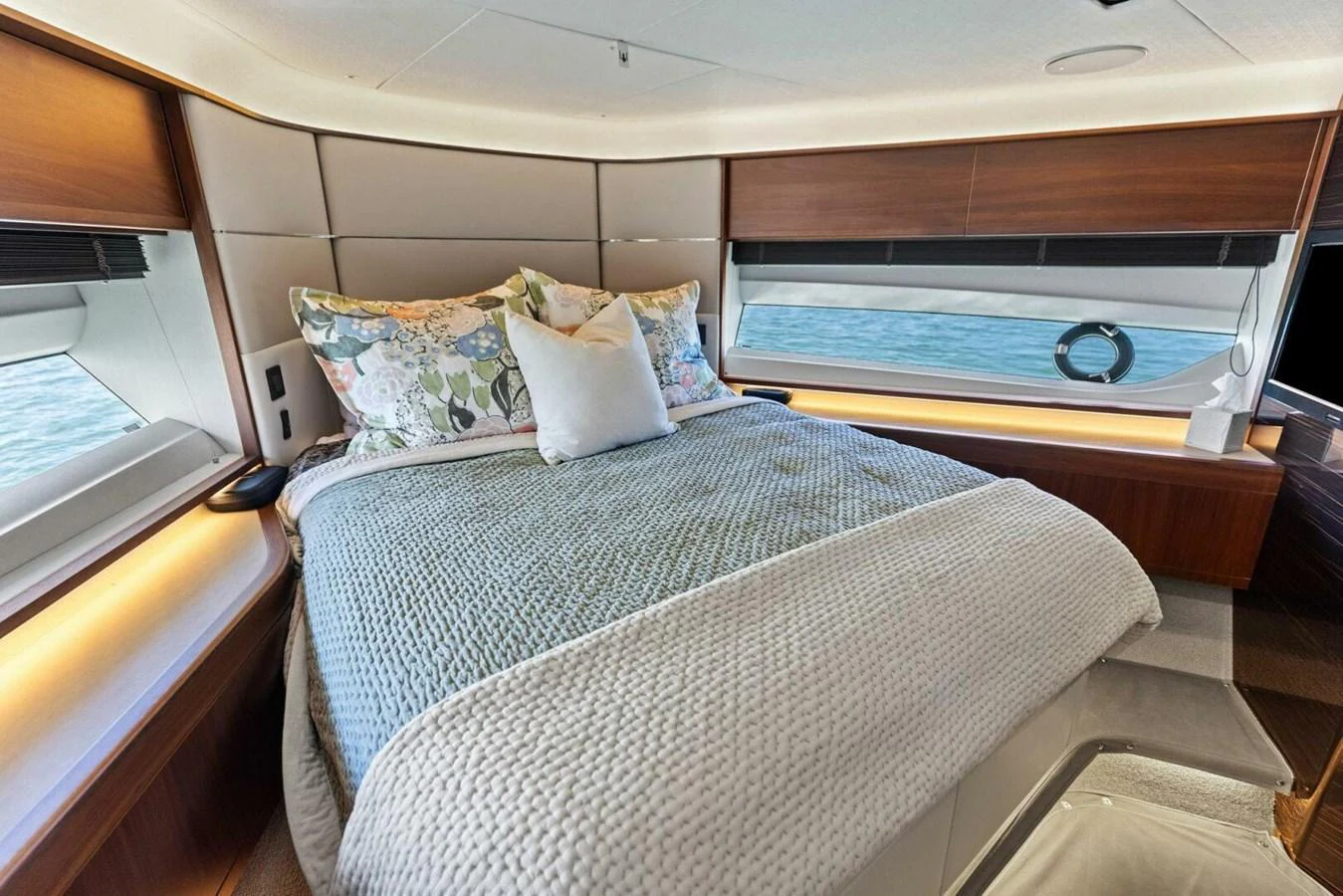 The stateroom features a plush bed with elegant bedding and ample natural light from large windows. aboard 3BBOYS Yacht for Sale