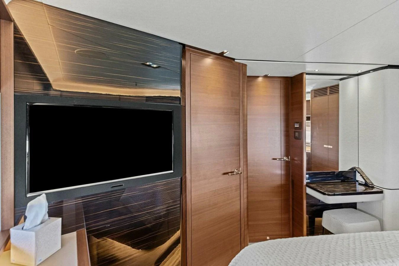 The yacht's interior features a modern design with wooden accents and a flat-screen TV. aboard 3BBOYS Yacht for Sale