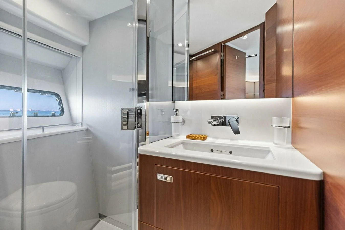 The yacht's bathroom features sleek wood cabinetry and modern fixtures, creating a luxurious and functional space. aboard 3BBOYS Yacht for Sale