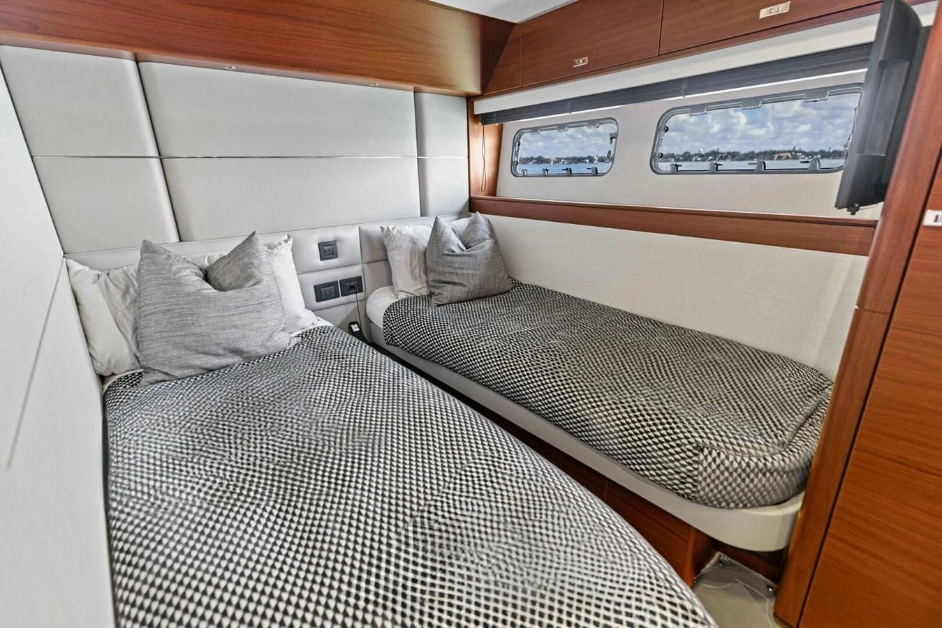 The twin stateroom offers a cozy and modern sleeping area with two single beds and ample natural light. aboard 3BBOYS Yacht for Sale