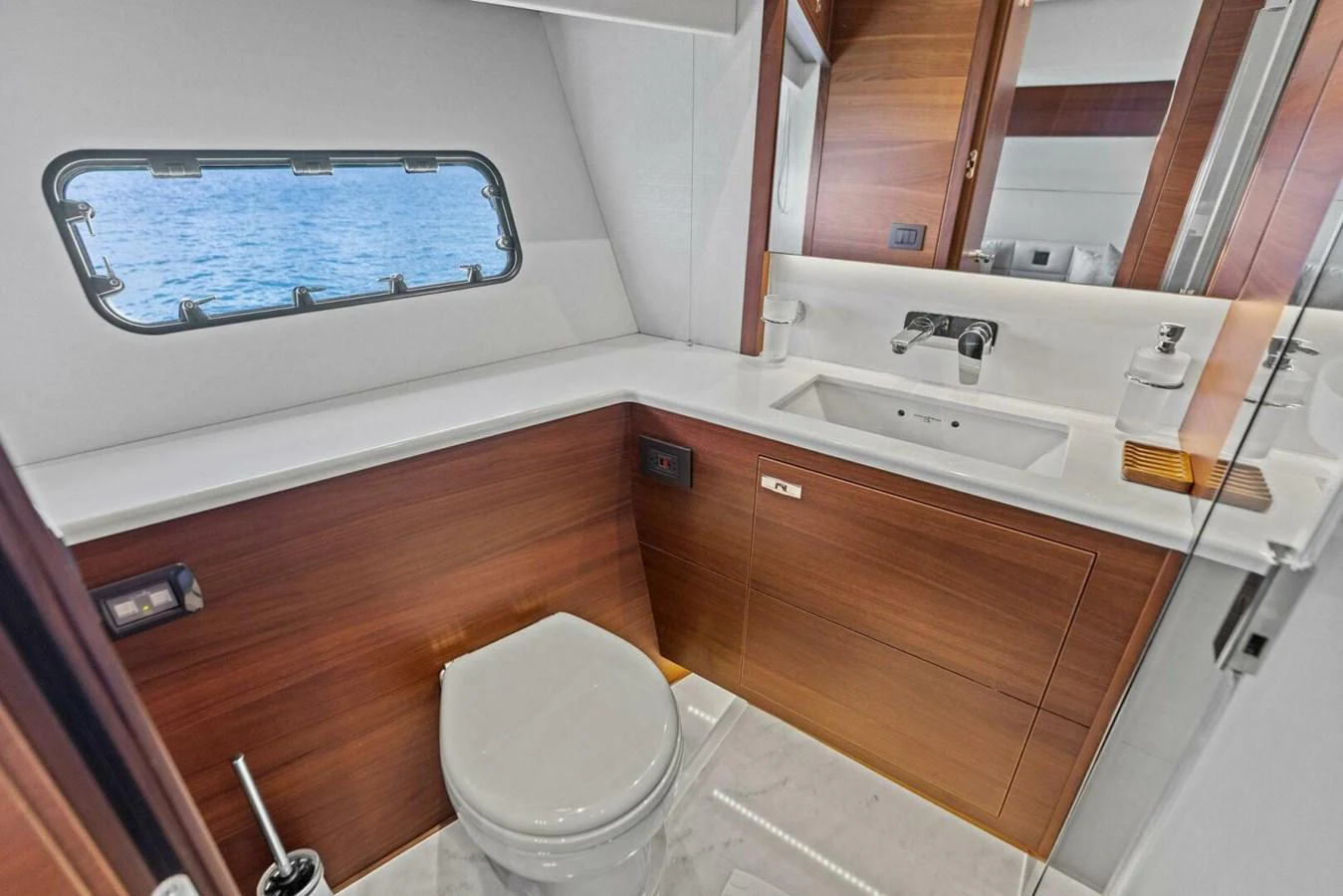 The yacht's bathroom features modern fixtures and a sleek design with a view of the sea through the window. aboard 3BBOYS Yacht for Sale