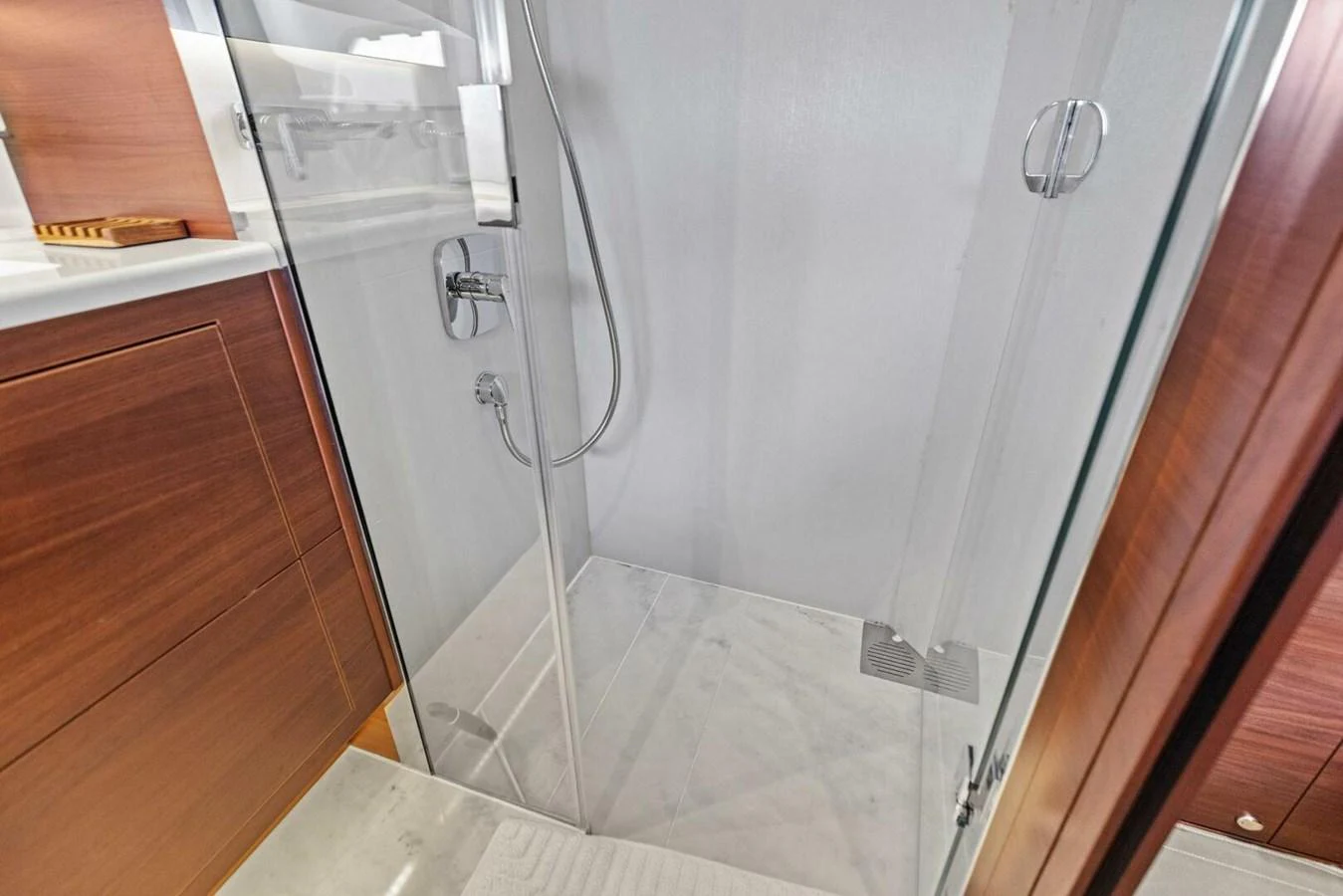 The yacht's bathroom features a sleek glass-enclosed shower with modern fixtures. aboard 3BBOYS Yacht for Sale