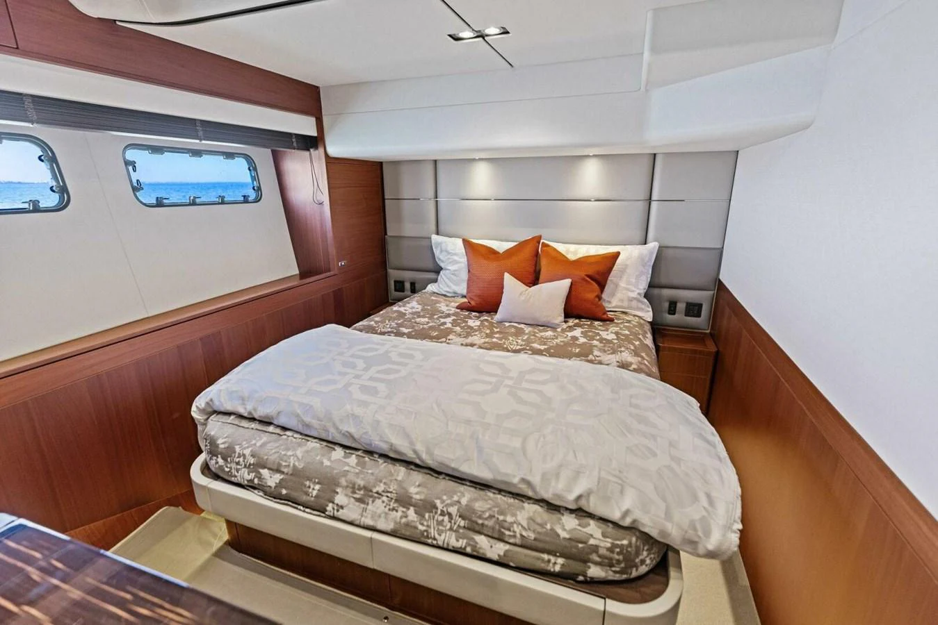 A cozy stateroom featuring a comfortable bed with elegant bedding and stylish decor. aboard 3BBOYS Yacht for Sale