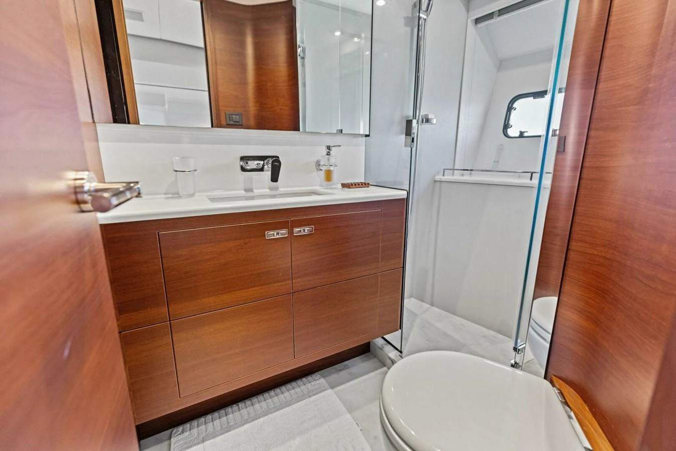 The yacht's bathroom features sleek wooden cabinetry and modern fixtures. aboard 3BBOYS Yacht for Sale