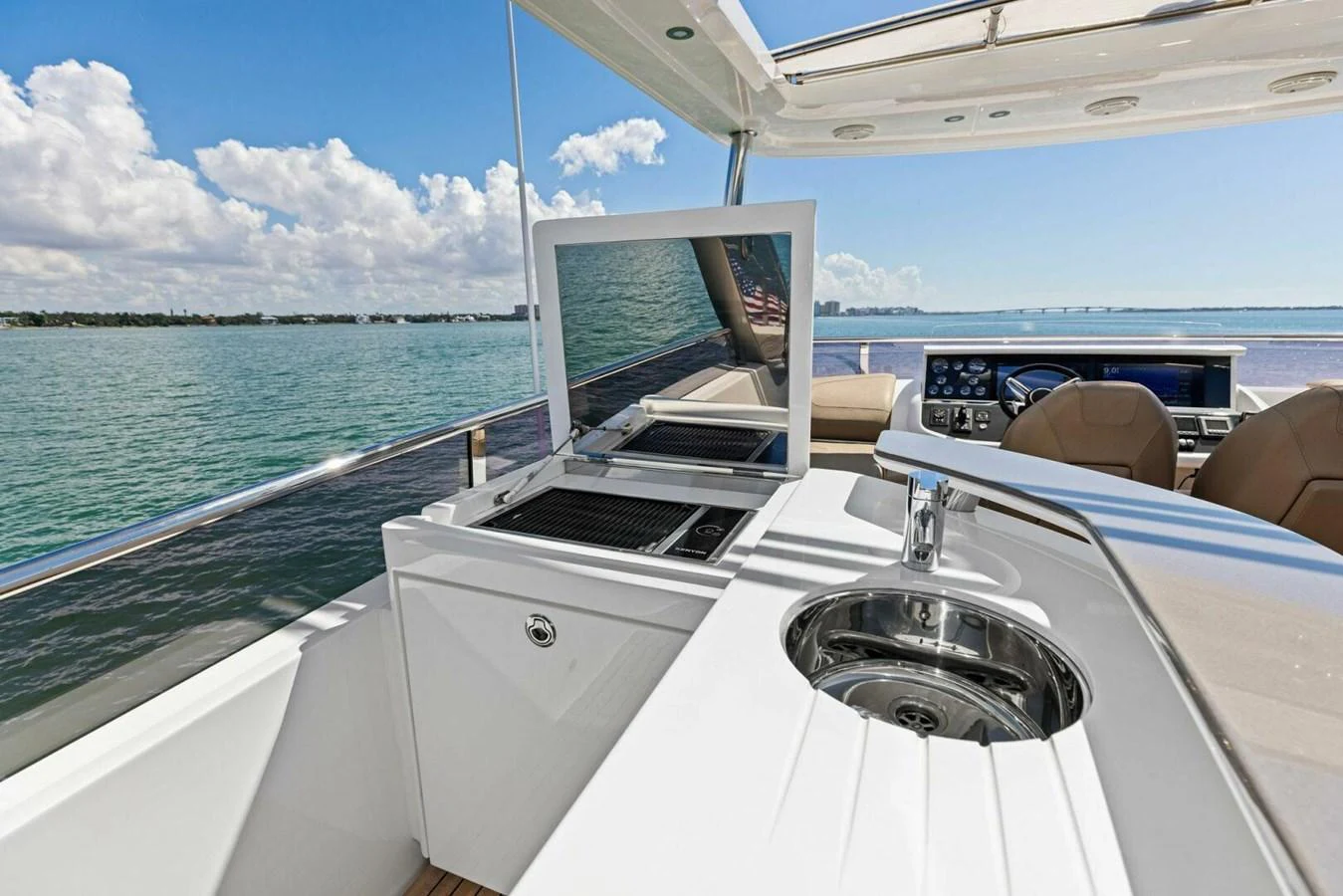 The flybridge features a sleek outdoor kitchen with a grill and sink, perfect for alfresco dining. aboard 3BBOYS Yacht for Sale
