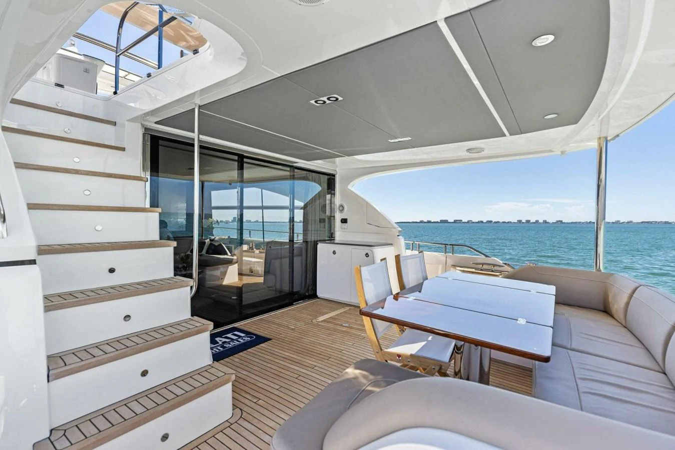 The aft deck features comfortable seating and a dining area with stunning ocean views. aboard 3BBOYS Yacht for Sale