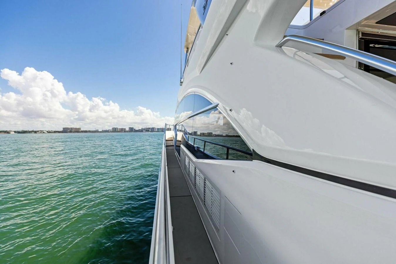 A sleek yacht cruising along the water with a clear view of the coastline. aboard 3BBOYS Yacht for Sale