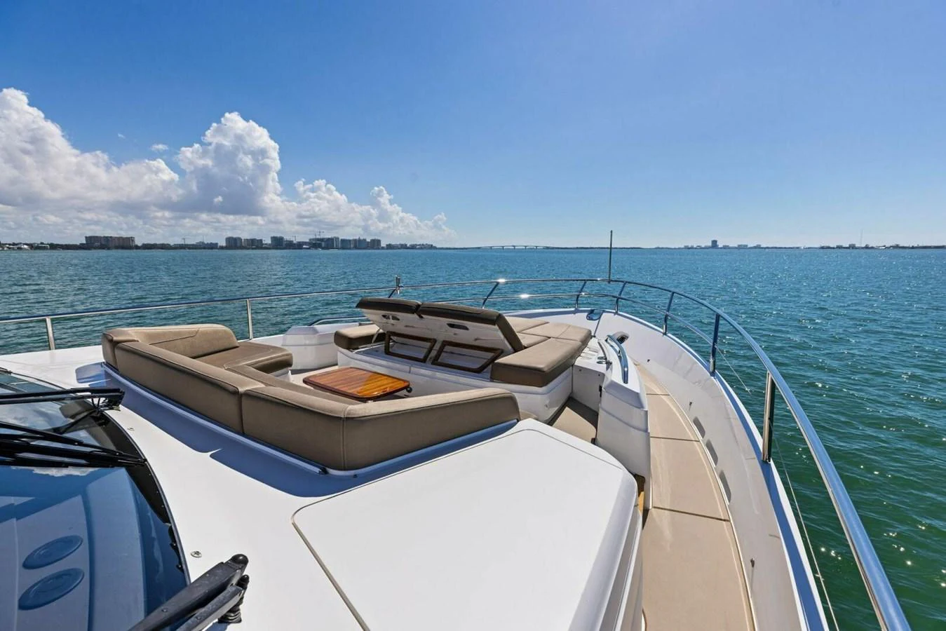 The yacht's foredeck features luxurious sun pads and seating with a stunning ocean view. aboard 3BBOYS Yacht for Sale