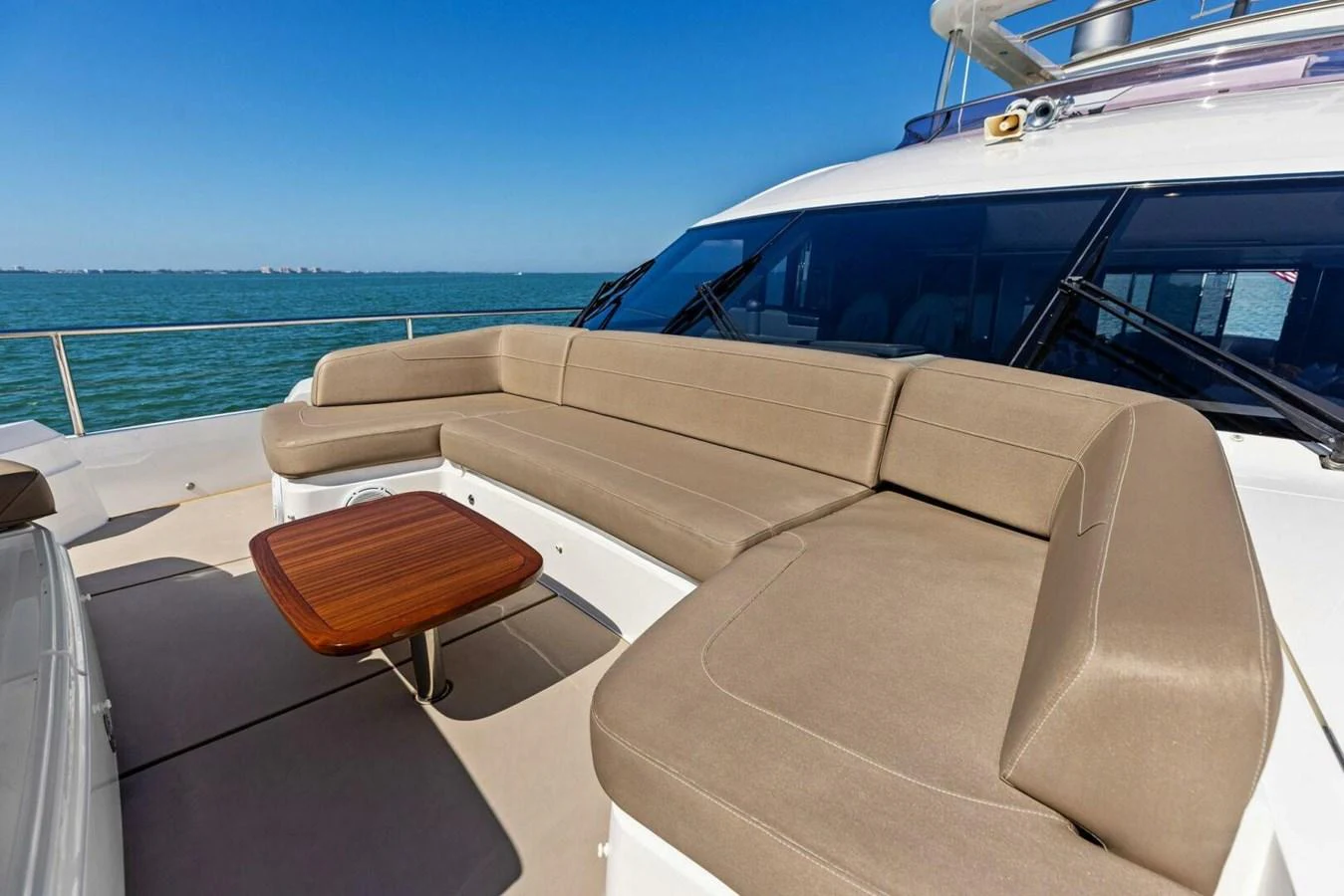 The flybridge features a spacious seating area with a wooden table, perfect for enjoying the sea views. aboard 3BBOYS Yacht for Sale